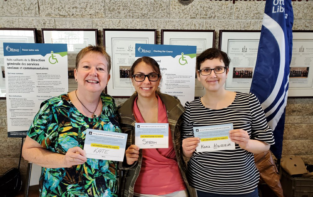 Three attendees showcase their own AbleTo pledge cards.