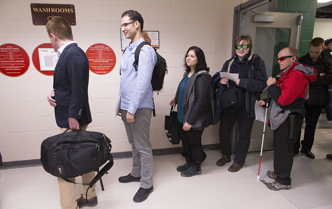 Students wait in line to attend an event at Algonquin College.