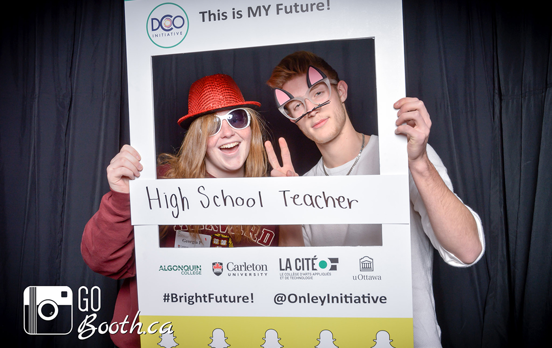 Two attendees pose at a DCOI photobooth activation.